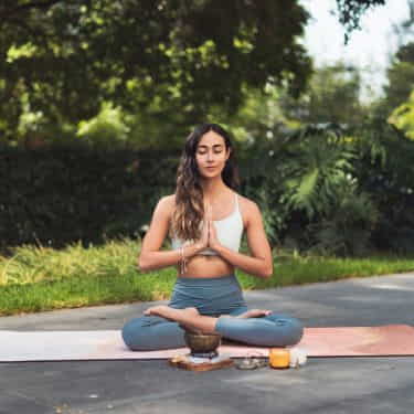 a woman sits and meditates