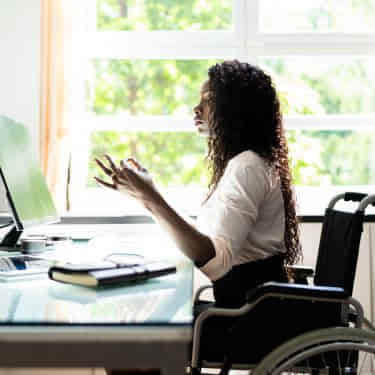 a woman practises mindfulness at her desk