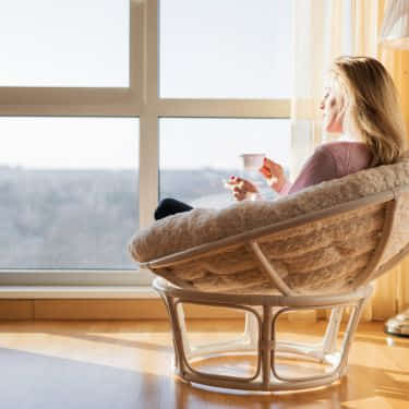 a woman is mindful by the window