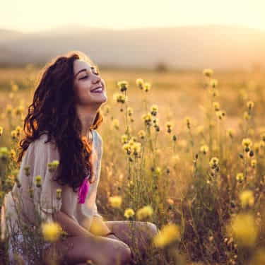 a girl sits in nature being mindful