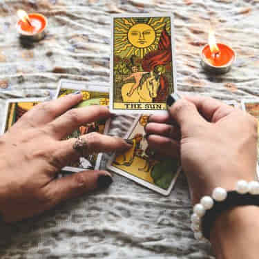 a tarot card reader deals the cards